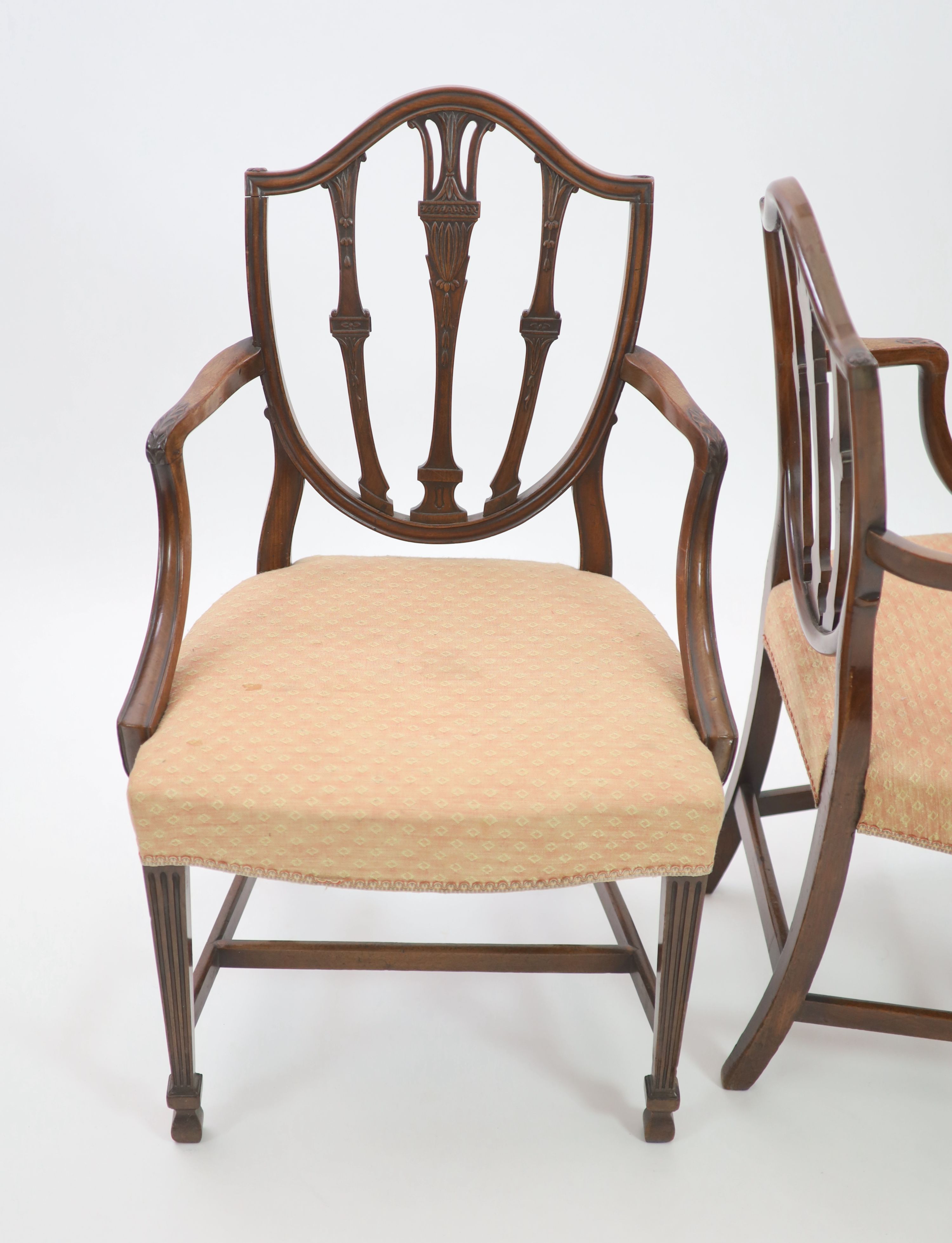A pair of George III Hepplewhite style mahogany shield back elbow chairs, W.62cm H.97cm